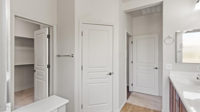 12693 N Rye Dr, Marana, AZ 85653 - bathroom with vanity and a walk in closet