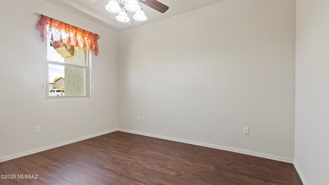 12693 N Rye Dr, Marana, AZ 85653 - unfurnished room with dark wood-style floors, a ceiling fan, and baseboards