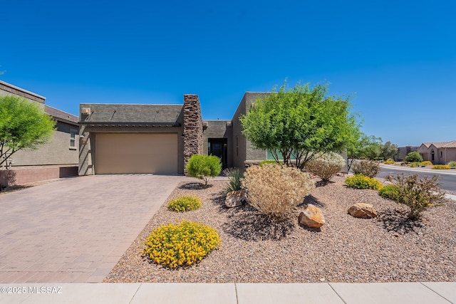 435 E Day Flower Dr, Tucson, AZ 85755 - view of front of property with stucco siding, an attached garage, and decorative driveway