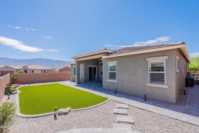 435 E Day Flower Dr, Tucson, AZ 85755 - rear view of house featuring a fenced backyard, a mountain view, stucco siding, and a patio area