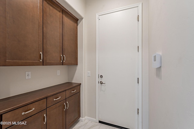 435 E Day Flower Dr, Tucson, AZ 85755 - doorway to outside featuring light marble finish flooring and baseboards