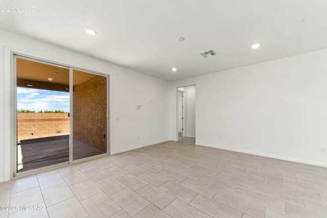empty room featuring recessed lighting, visible vents, and baseboards