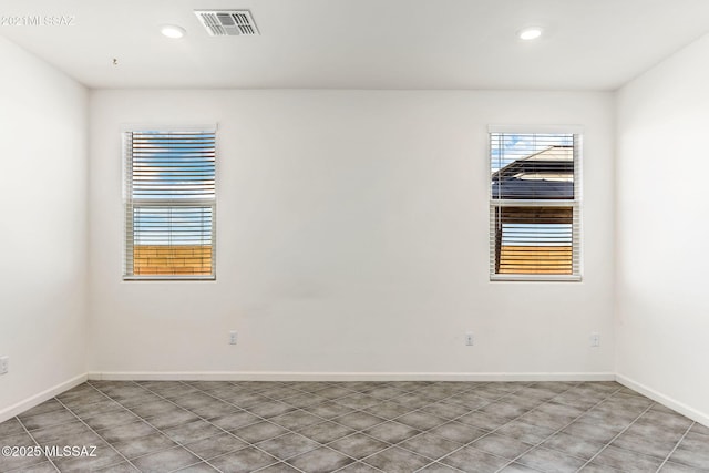 unfurnished room featuring tile patterned flooring, baseboards, visible vents, and recessed lighting
