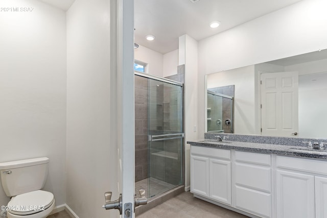 bathroom with a sink, double vanity, and a stall shower
