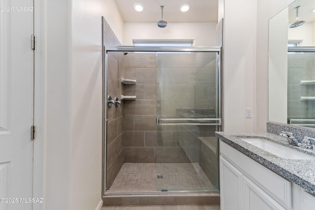 bathroom with vanity and a stall shower