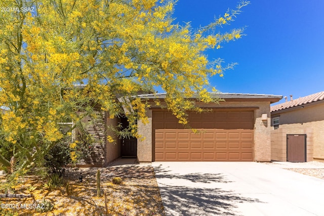 view of front facade with a garage, stucco siding, and concrete driveway