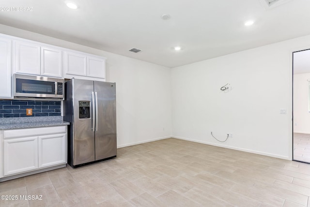 kitchen featuring white cabinets, recessed lighting, stainless steel appliances, backsplash, and visible vents