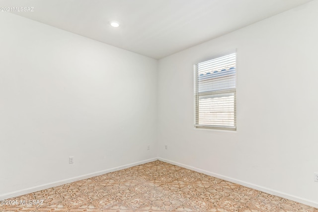unfurnished room featuring recessed lighting, a healthy amount of sunlight, and baseboards