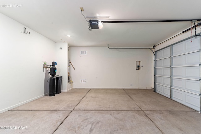 garage featuring baseboards, visible vents, recessed lighting, and a garage door opener