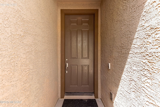 property entrance featuring stucco siding