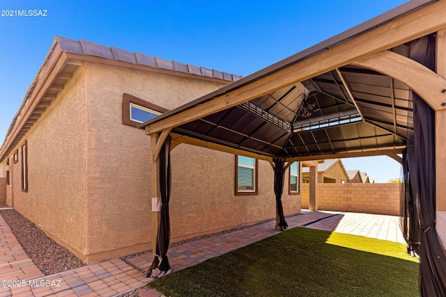 exterior space with fence and a gazebo