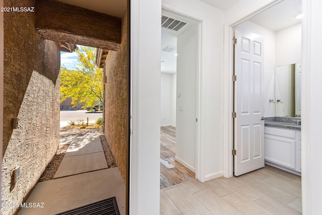 interior space with light wood-type flooring and visible vents
