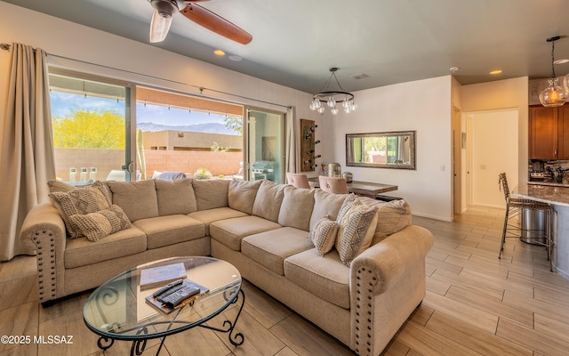 13274 Humphreys Peak Dr, Oro Valley, AZ 85755 - living room with baseboards, recessed lighting, ceiling fan with notable chandelier, and light wood finished floors