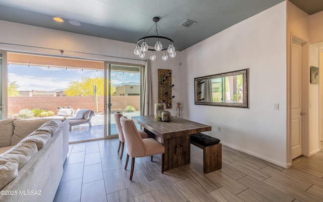 13274 Humphreys Peak Dr, Oro Valley, AZ 85755 - dining area with an inviting chandelier, wood tiled floor, visible vents, and baseboards