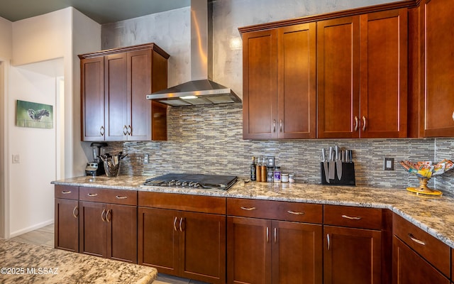 13274 Humphreys Peak Dr, Oro Valley, AZ 85755 - kitchen featuring light stone counters, stainless steel gas stovetop, decorative backsplash, and wall chimney exhaust hood