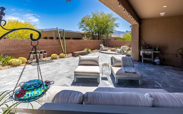 13274 Humphreys Peak Dr, Oro Valley, AZ 85755 - view of patio / terrace featuring an outdoor living space, a mountain view, a fenced backyard, and grilling area