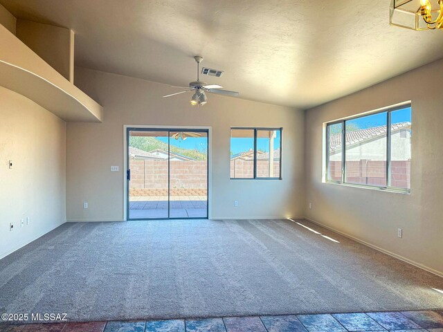 2582 W Brandy Crest Dr, Tucson, AZ 85713 - carpeted empty room featuring plenty of natural light, lofted ceiling, ceiling fan, baseboards, and a textured ceiling