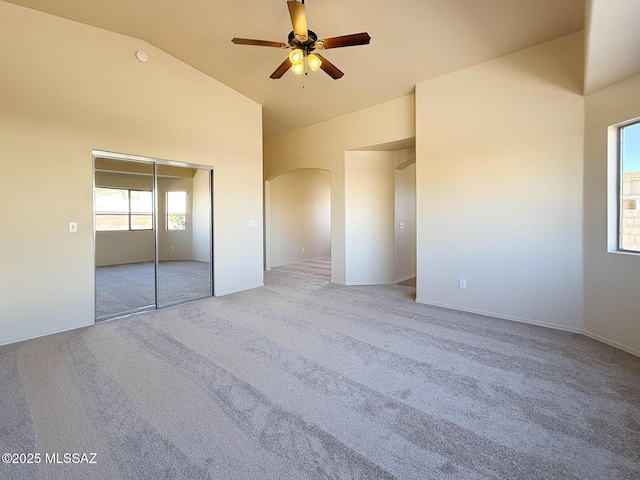 2582 W Brandy Crest Dr, Tucson, AZ 85713 - unfurnished bedroom featuring carpet flooring, arched walkways, high vaulted ceiling, a closet, and a ceiling fan