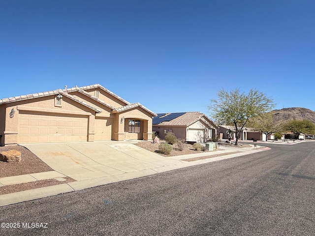 2582 W Brandy Crest Dr, Tucson, AZ 85713 - view of front facade featuring driveway, stucco siding, a garage, and a tile roof