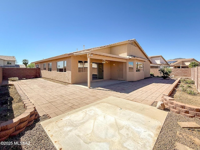 2582 W Brandy Crest Dr, Tucson, AZ 85713 - back of property with a fenced backyard, stucco siding, and a patio area