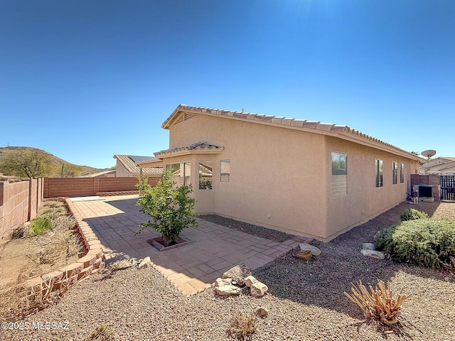 2582 W Brandy Crest Dr, Tucson, AZ 85713 - rear view of house with stucco siding, a fenced backyard, and a patio area