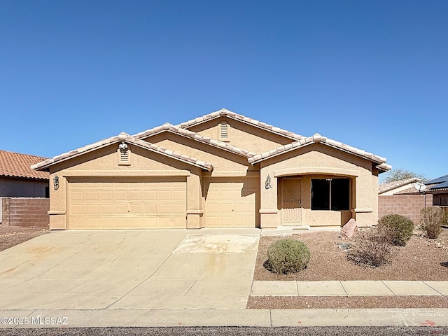 2582 W Brandy Crest Dr, Tucson, AZ 85713 - single story home with driveway, an attached garage, stucco siding, and a tile roof