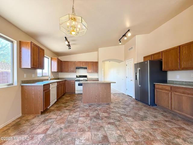2582 W Brandy Crest Dr, Tucson, AZ 85713 - kitchen featuring white appliances, rail lighting, a sink, a chandelier, and vaulted ceiling