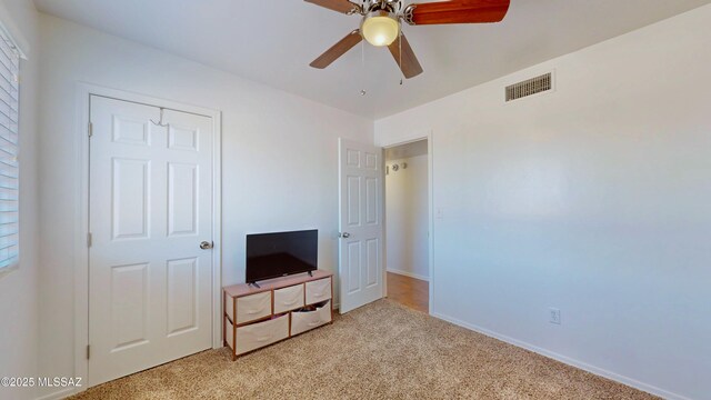 502 N Citadel Ave, Tucson, AZ 85748 - unfurnished bedroom featuring baseboards, visible vents, light colored carpet, and ceiling fan