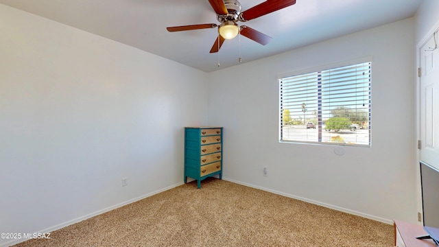 502 N Citadel Ave, Tucson, AZ 85748 - unfurnished room featuring light carpet, a ceiling fan, and baseboards
