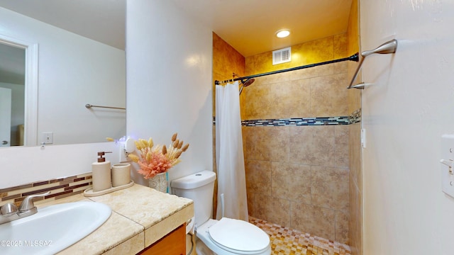 502 N Citadel Ave, Tucson, AZ 85748 - bathroom with toilet, tiled shower, visible vents, decorative backsplash, and vanity