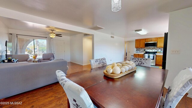 502 N Citadel Ave, Tucson, AZ 85748 - dining space featuring visible vents, a ceiling fan, baseboards, and dark wood-style flooring