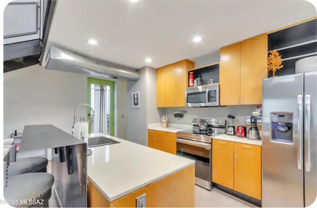 kitchen featuring a sink, appliances with stainless steel finishes, open shelves, and light countertops