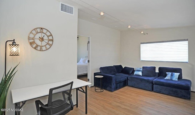 living area with visible vents and light wood-type flooring