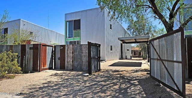 view of property exterior with fence and a gate