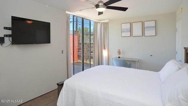 bedroom with a ceiling fan and access to exterior
