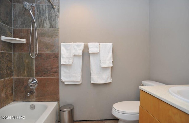 bathroom featuring toilet,  shower combination, and vanity
