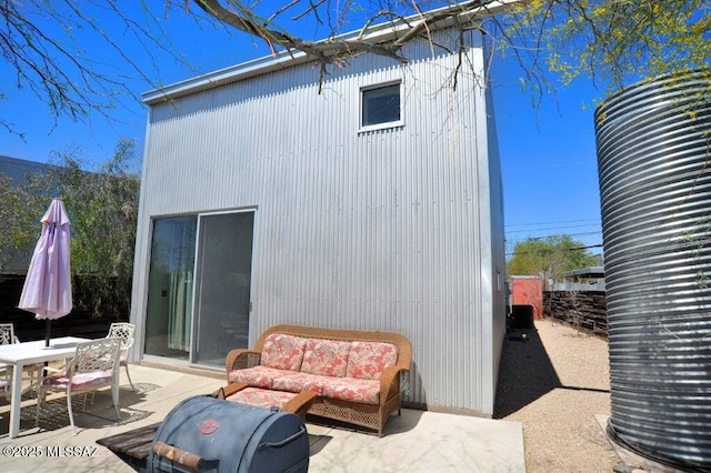 back of house featuring fence, outdoor dining area, and a patio area