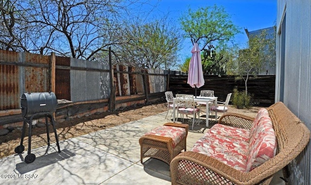 view of patio with a fenced backyard, outdoor dining area, and area for grilling