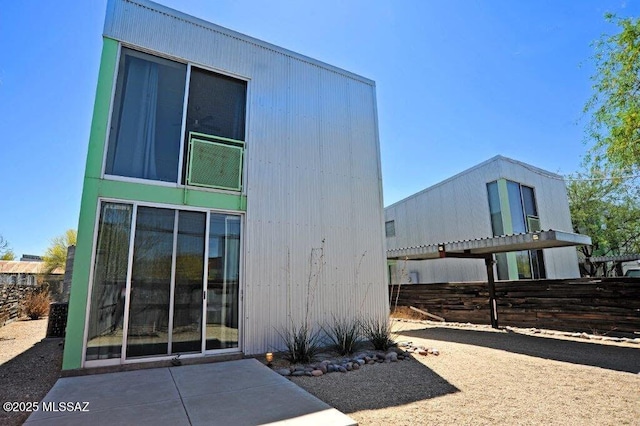 rear view of property featuring fence