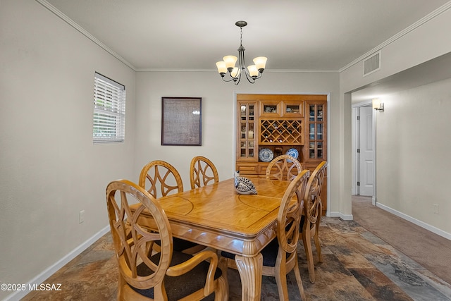 dining room with stone tile flooring, visible vents, baseboards, a chandelier, and ornamental molding