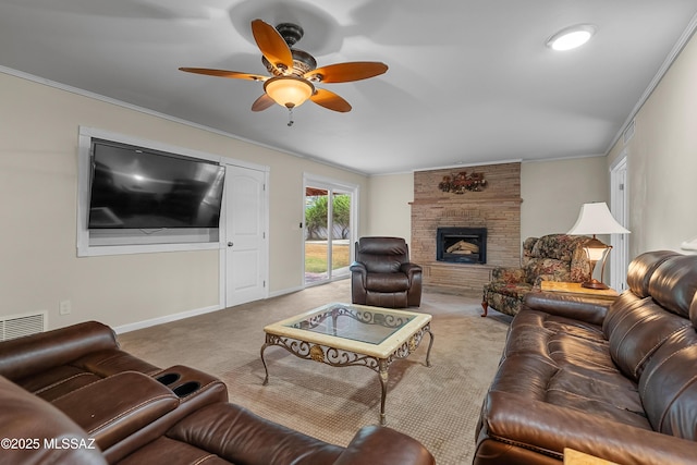 living room featuring a fireplace, carpet floors, ornamental molding, and ceiling fan