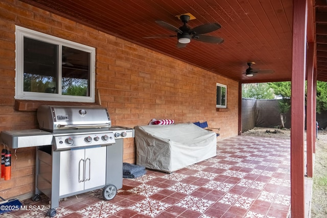 view of patio featuring a grill, fence, and a ceiling fan