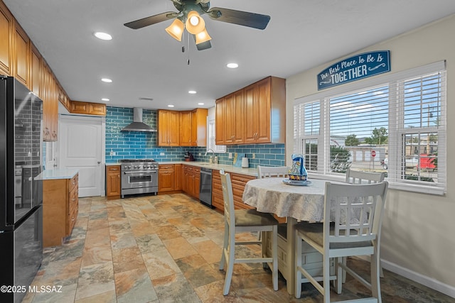 kitchen with stainless steel appliances, tasteful backsplash, recessed lighting, ceiling fan, and wall chimney range hood