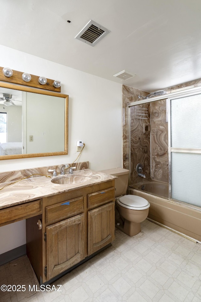 601 N Sahuara Ave, Tucson, AZ 85711 - full bathroom with visible vents, vanity, tile patterned floors, combined bath / shower with glass door, and toilet