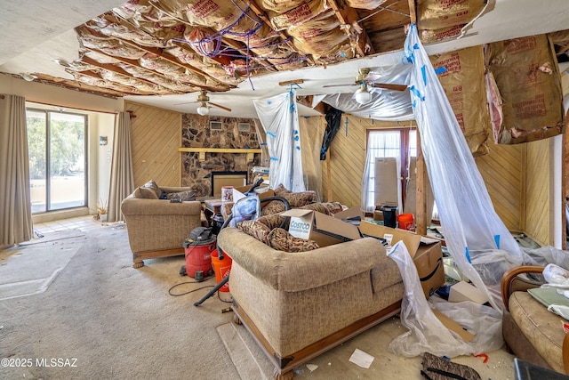 601 N Sahuara Ave, Tucson, AZ 85711 - living room with a healthy amount of sunlight, ceiling fan, carpet flooring, and wood walls