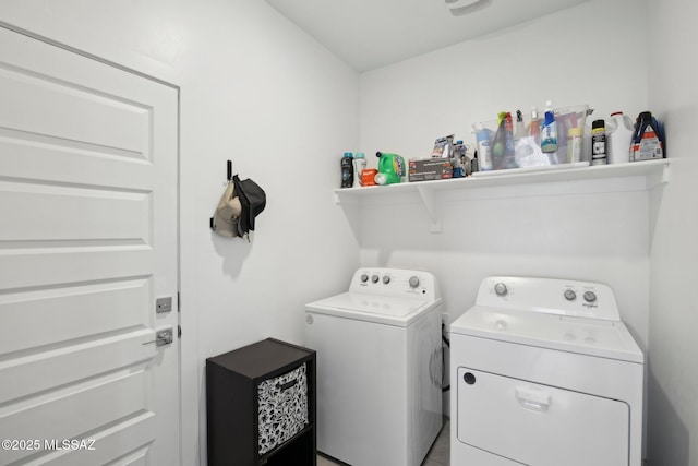 washroom with washing machine and clothes dryer and laundry area