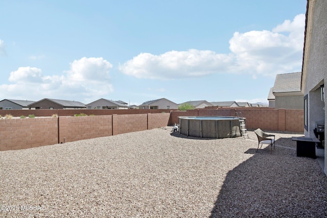 view of yard with a fenced in pool and a fenced backyard