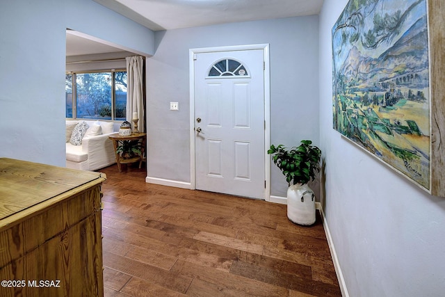 foyer entrance with baseboards and wood finished floors