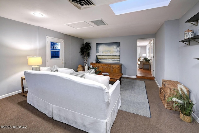 carpeted living area with attic access, baseboards, and visible vents