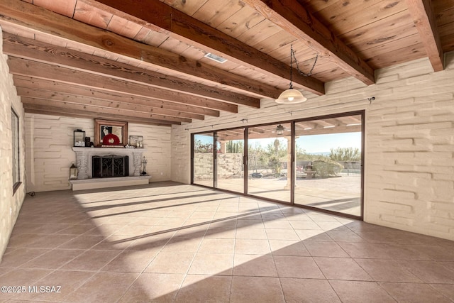 unfurnished living room with wood ceiling, beam ceiling, tile patterned flooring, and ceiling fan